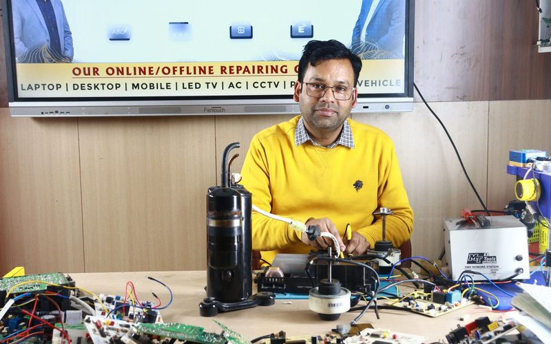 Technician diagnosing an air conditioner control board during a service visit