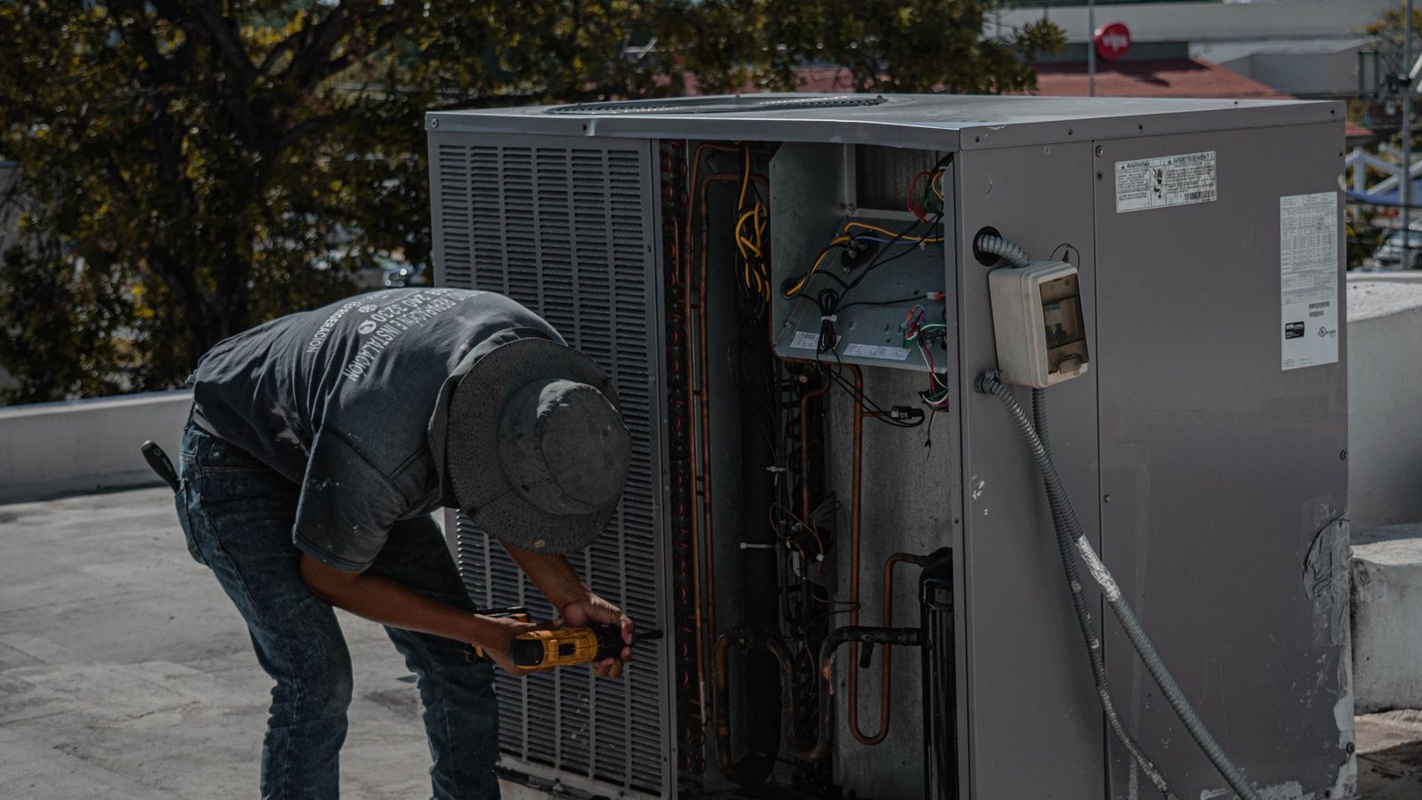Namra Tech Solutions technician servicing a split AC outdoor unit at a home in Gurgaon