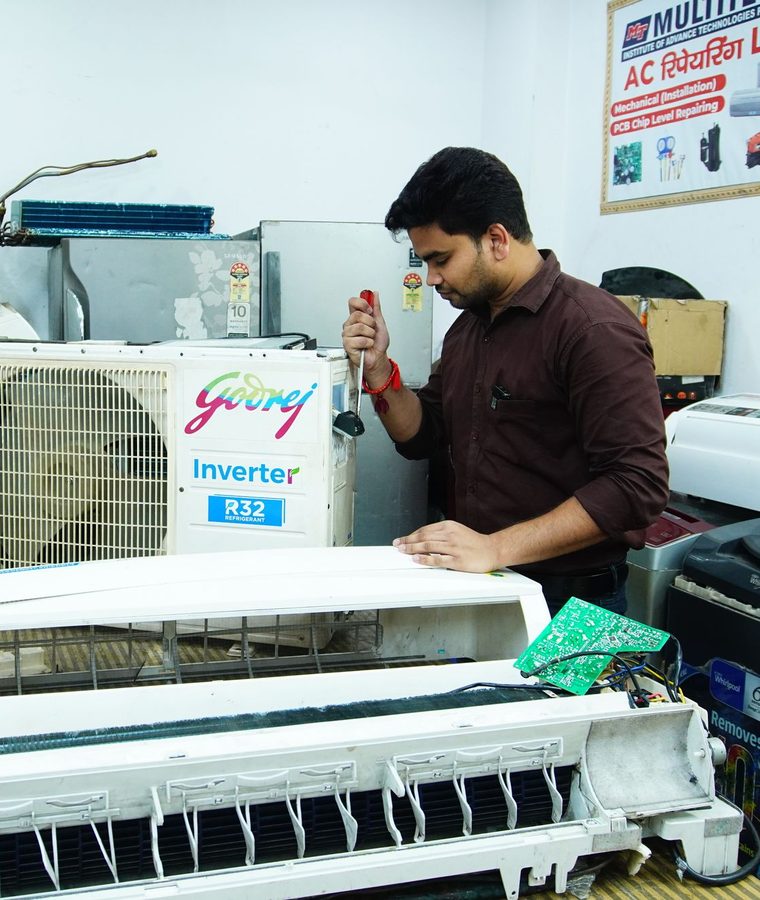 Verified Namra Tech Solutions technician repairing a split AC indoor unit